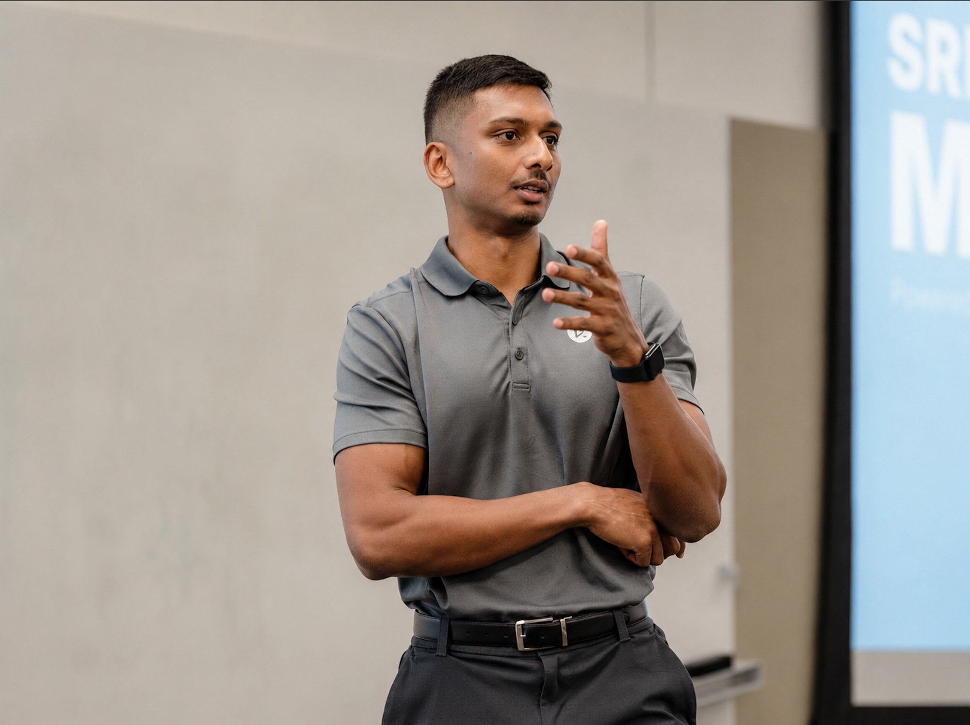 Nicholas Prasad speaking and gesturing while delivering a keynote