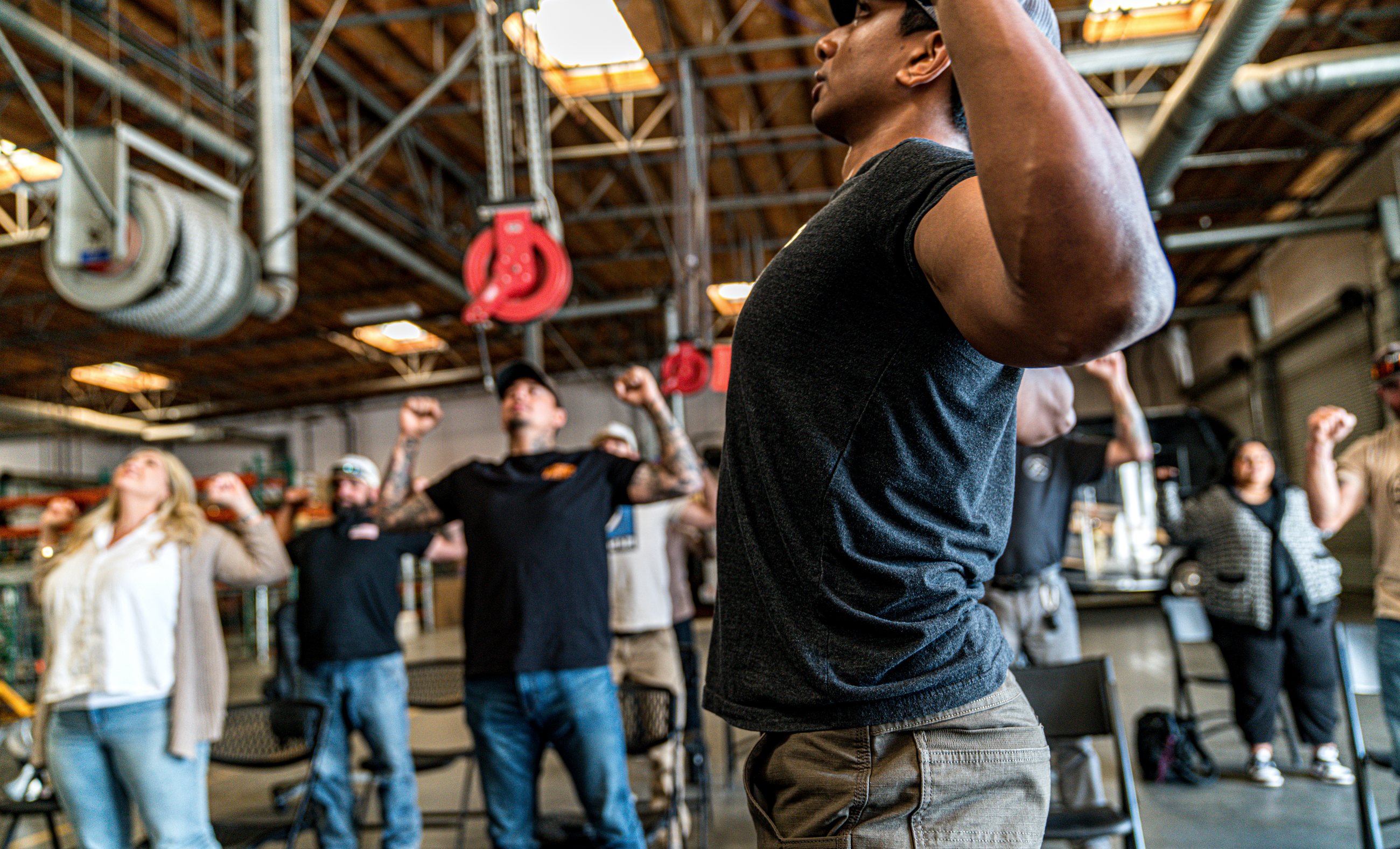 Nicholas Prasad leading an industrial crew through a mobility session in an equipment bay